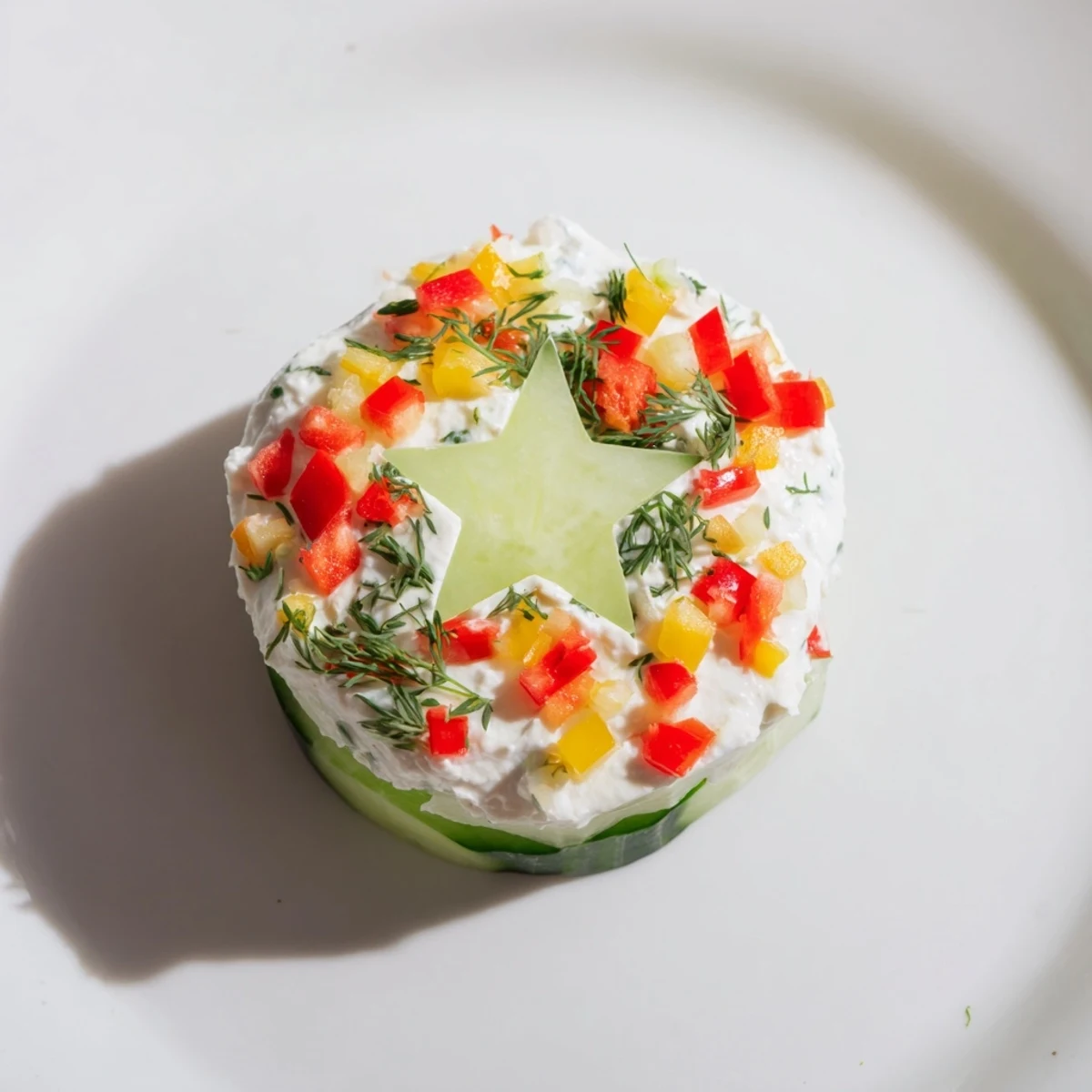 Festive Holiday Star Cucumber Bites topped with colorful bell peppers and fresh dill, ready to serve.