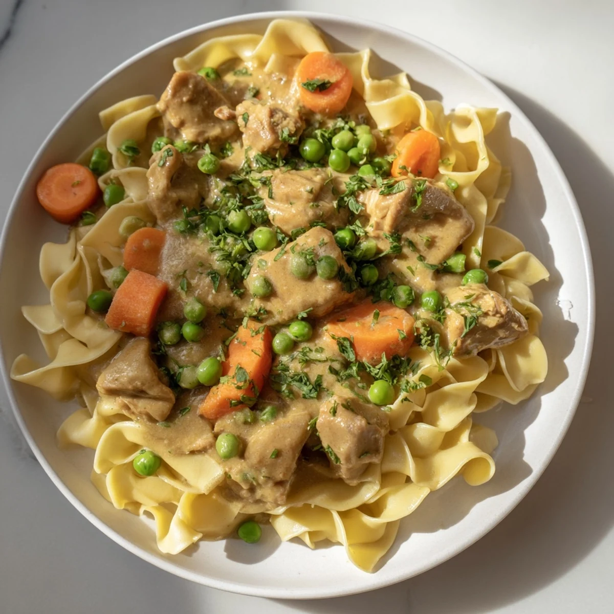 Creamy Chicken and Egg Noodles: A hearty bowl of comfort with glistening sauce and fresh parsley.