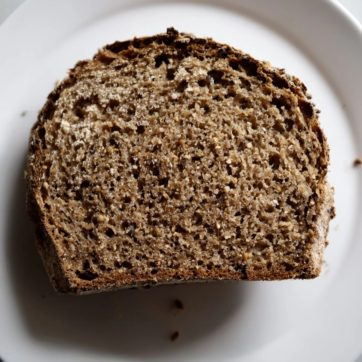 Dense, aromatic Latvian Rupjmaize bread, freshly baked with a wonderfully chewy interior, perfect for serving.
