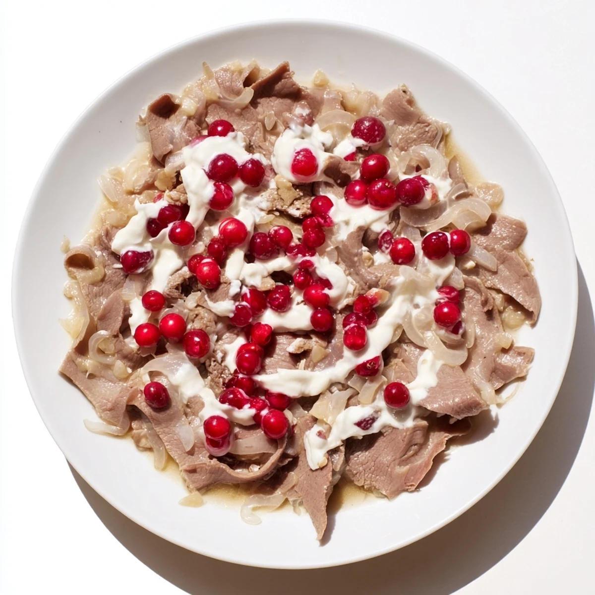 Tender reindeer meat in Finnish Reindeer Stew, cooked in a flavorful broth, is topped with sour cream.