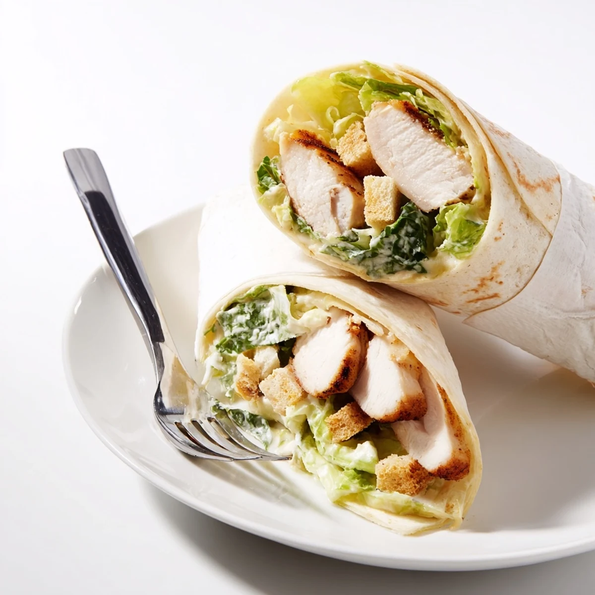 Grilled chicken slices and crisp romaine lettuce tossed in creamy Caesar dressing inside a flour tortilla.