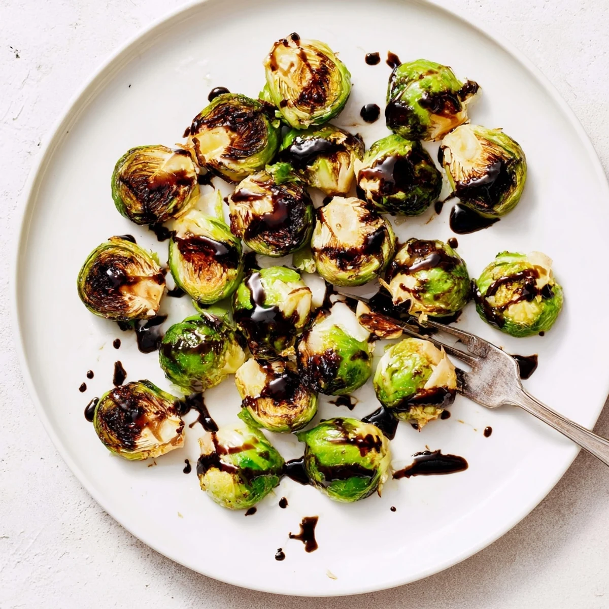 Whole roasted Brussels sprouts with balsamic glaze, perfect for a holiday table or easy weeknight vegetarian side dish.