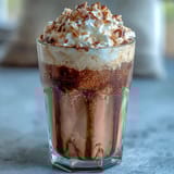 Iced Vanilla Bean Frappuccino with Toasted Coconut Foam: creamy vanilla frappuccino blended with coffee and ice, crowned with airy toasted coconut foam for a tropical twist.