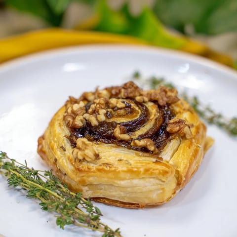 Warm, melted Baked Brie with Fig Jam complements crunchy crackers, an ideal party snack.