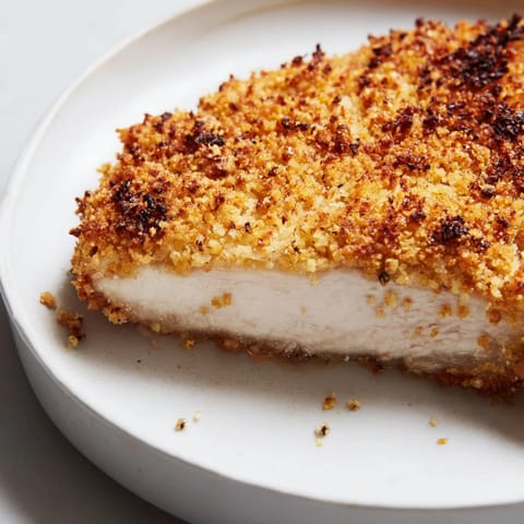 A close-up shot of perfectly breaded air fryer chicken cutlets, smelling delicious and savory.