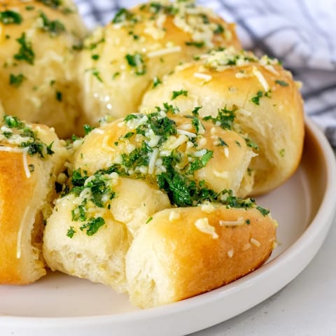 Warm, cheesy Garlic Butter Bread Pull-Apart rolls are perfect for dipping into marinara or enjoying as a comforting appetizer.  