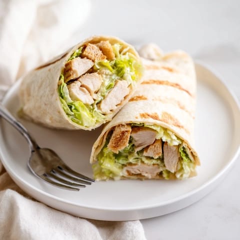 Freshly grated parmesan and crunchy croutons add texture to this hearty Caesar Chicken Salad Wrap.
