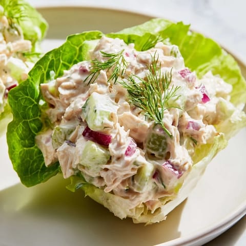 A close-up of dill pickle chicken salad nestled in fresh romaine, perfect for a low-carb lunch.