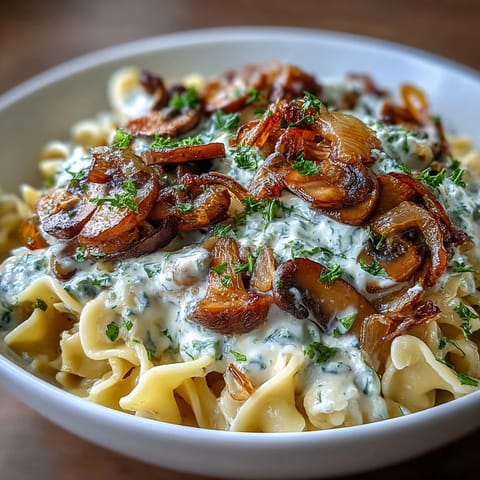 A creamy vegetarian stroganoff with tender onions and mushrooms over egg noodles.  