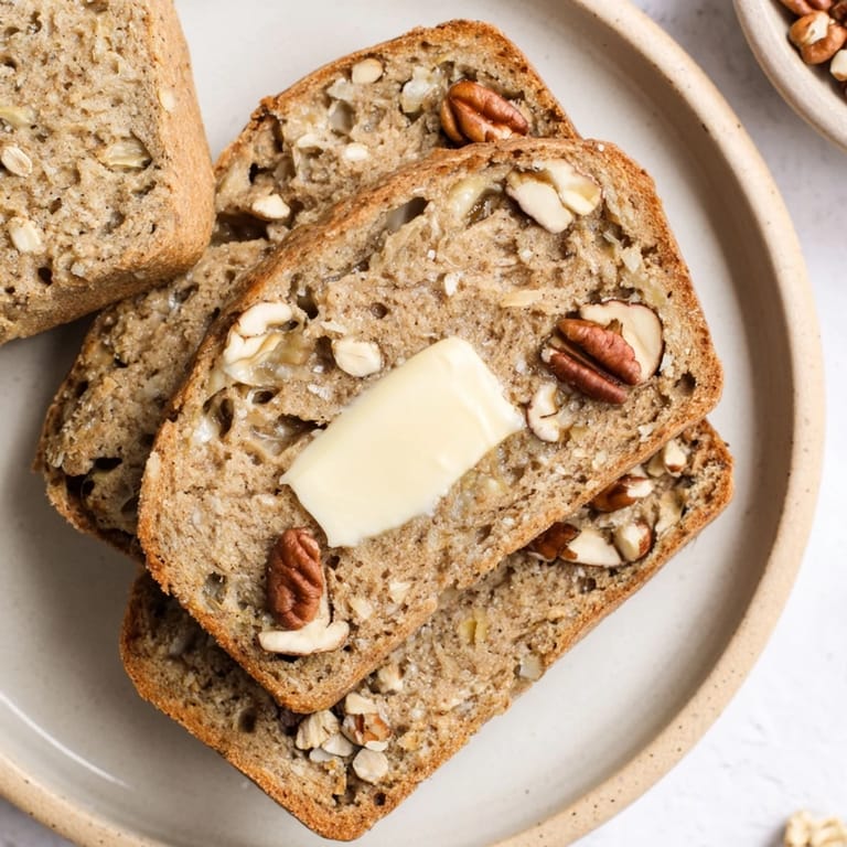 Sliced Nutty Whole Wheat Loaf Bread displaying visible nuts; perfect for sandwiches or enjoying with butter.