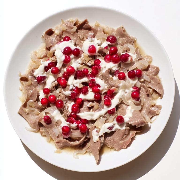 Tender reindeer meat in Finnish Reindeer Stew, cooked in a flavorful broth, is topped with sour cream.