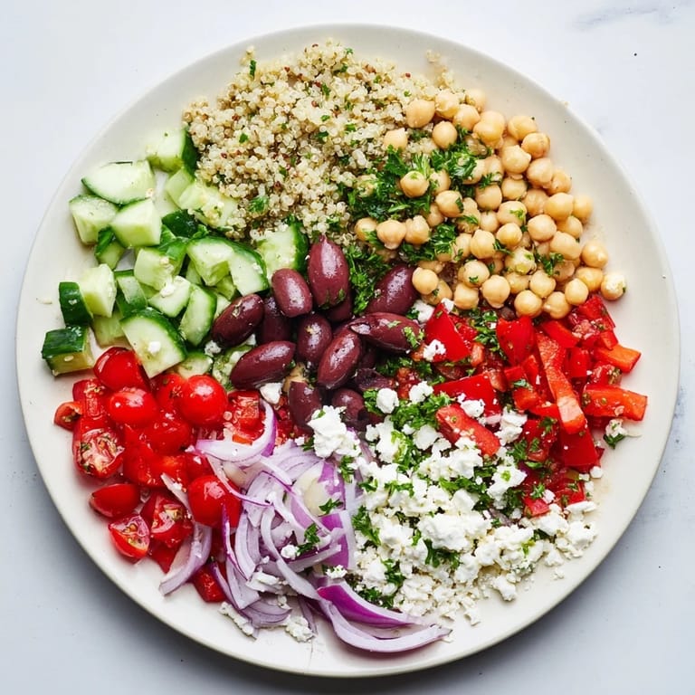 Tossing the Greek Power Salad with a zesty vinaigrette, featuring crunchy cucumbers, tomatoes, and Kalamata olives.