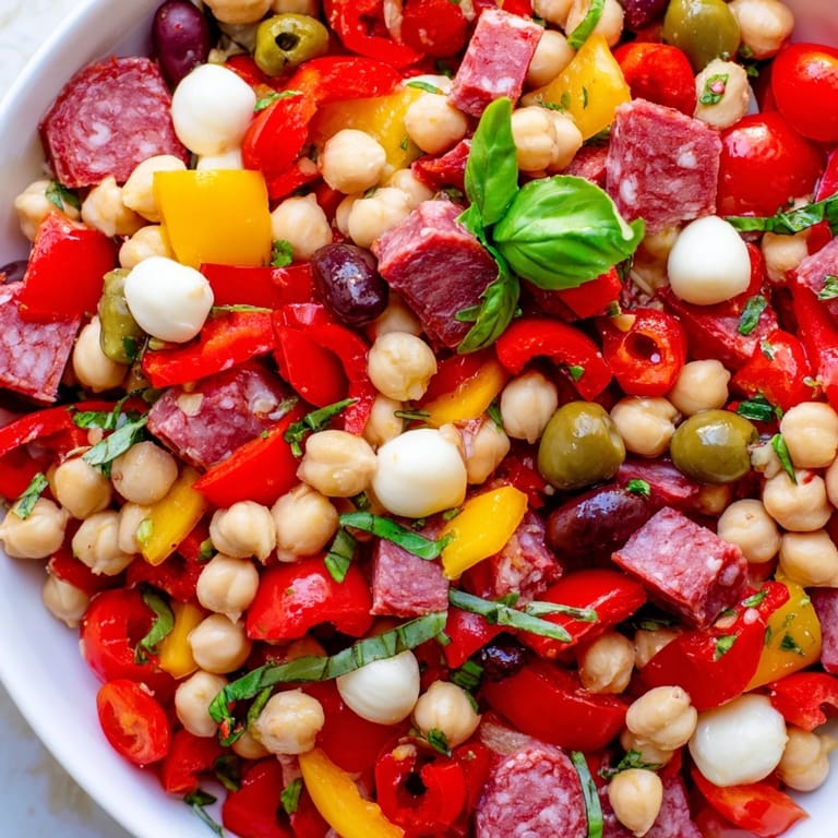 Gluten-free crunchy antipasto chopped salad with olives, pepperoncini, tomatoes, and basil, tossed in a homemade red wine vinaigrette.