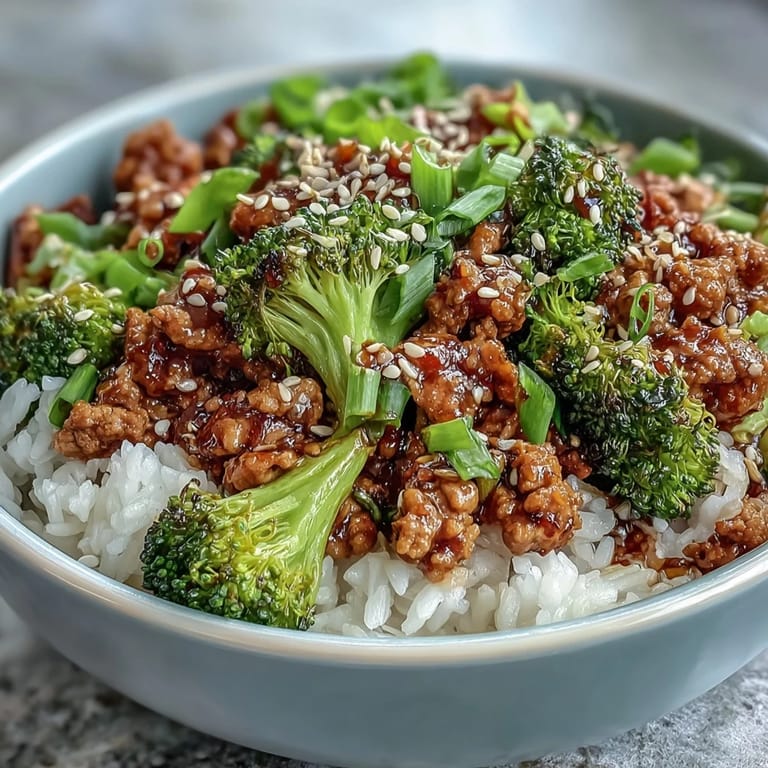 Dinner serving of Sweet and Spicy Turkey Broccoli Bowls with tender turkey, steamed broccoli, and nutty brown rice drizzled in a glossy Asian-inspired glaze.