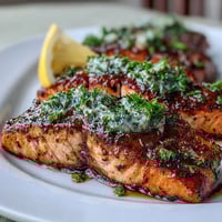 Herb-roasted salmon with asparagus, fresh dill, and lemon slices on a baking sheet, perfect for a healthy dinner.